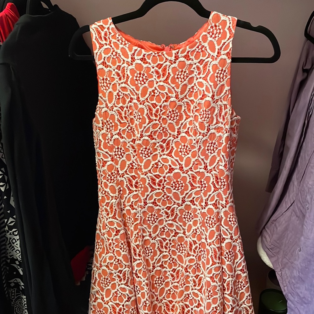 Coral dress with white lace.